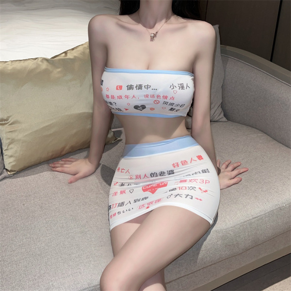 Woman wearing a white lace bodysuit and micro mini skirt set with playful text, sitting on a beige couch.