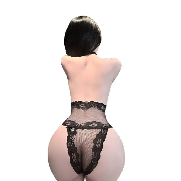 Woman wearing black lace lingerie set with sheer fabric and floral details, back view.