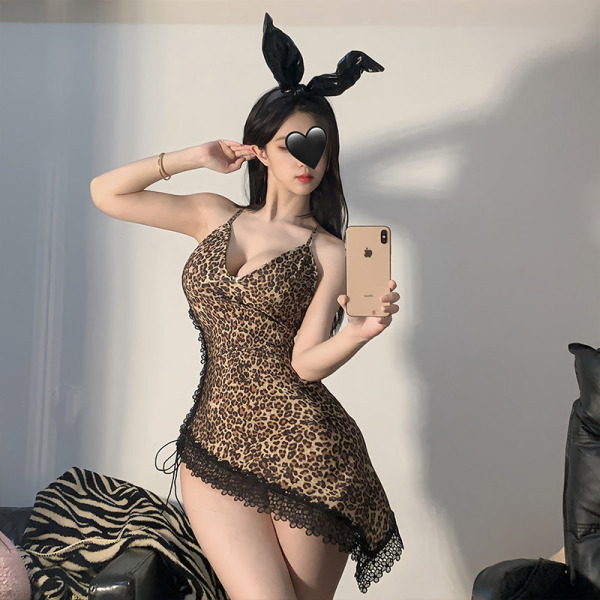 Woman wearing sexy leopard print lingerie set with bunny ears, taking a mirror selfie.