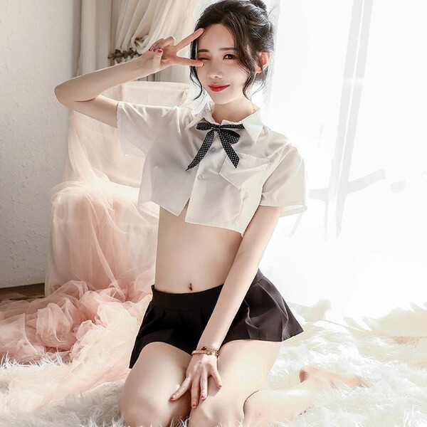 Woman modeling sexy sheer white jk uniform shirt with bow and black pleated skirt, no-remove design.
