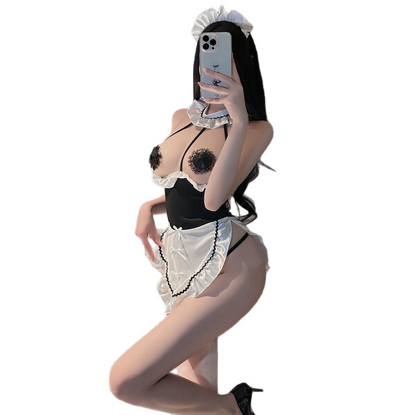 Woman in suqing sexy lace maid costume set with neck strap apron and ruffled trim, posing seductively for mirror selfie.