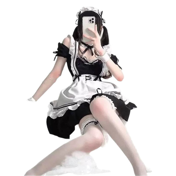 A woman poses wearing a black and white maid costume, featuring ruffled sleeves, lace details, and stockings, perfect for cos...