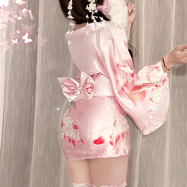 A woman wears a pink yasu sexy deep-v anime kimono lingerie set, featuring floral patterns and a bow tie, perfect for japanes...