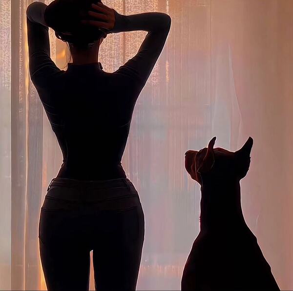 Silhouette of a woman and dog by window, wearing a purple lace backless tight t-shirt, exuding elegance and comfort.