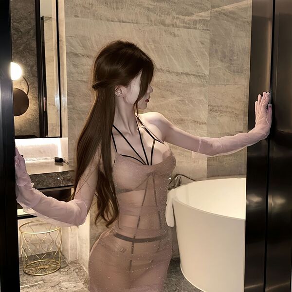Woman in plus size sheer lace bondage outfit with long gloves, posing in modern bathroom for date night or bedroom wear.