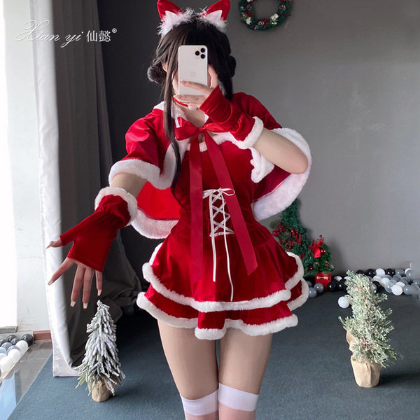 A person wearing a festive santa-themed outfit, featuring a red and white dress with fur trimmings, gloves, stockings, and re...