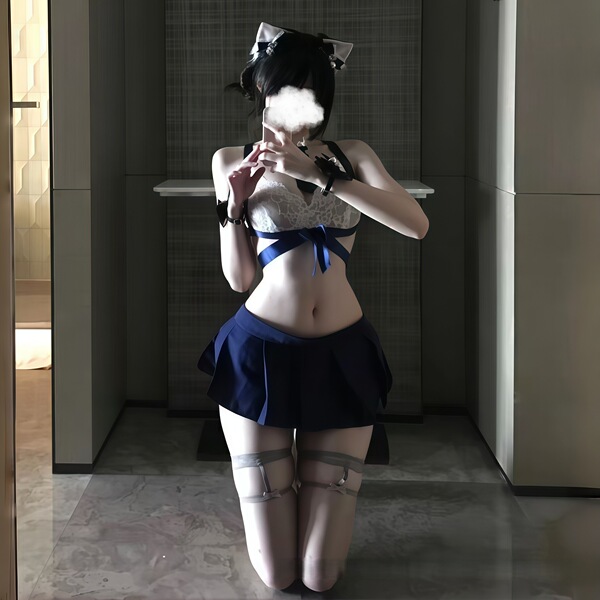 A person poses in a mirror wearing a new schoolgirl jk uniform lingerie set, featuring a white bra with blue accents and a na...