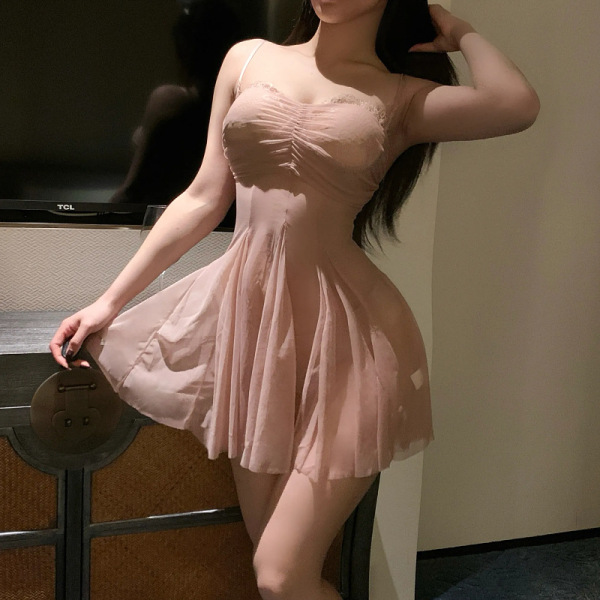 Woman wearing a seductive lace mesh slip dress set, featuring a busty plus size provocative lingerie outfit in soft pink.