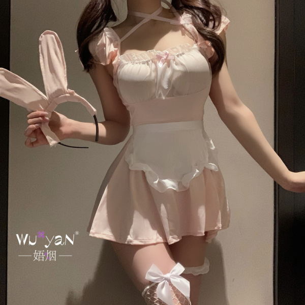 Woman modeling a pink and white seductive sleepwear set with bunny ears headband, featuring a frilly top, apron-style skirt, ...