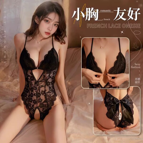 Woman modeling black lace open-crotch bodysuit with sheer panels and bow detail — sexy sleepwear for women.