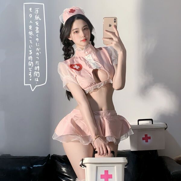 Woman modeling pink sexy nurse costume with skirt, cap, and props for role play.