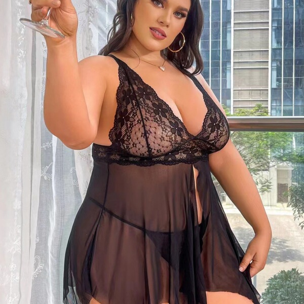 Woman wearing black lace halter nightgown, sheer plus size sleep dress with elegant floral detailing.