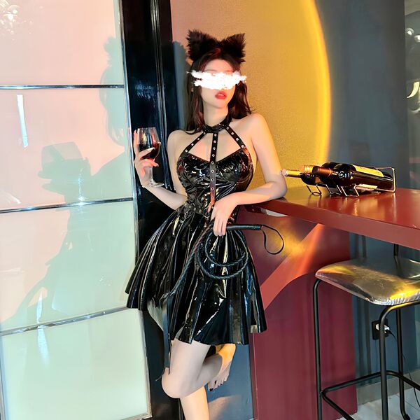 Woman in shiny black pvc catwoman costume with lace-up bodysuit, garter belt, cat ears, holding wine glass at bar.