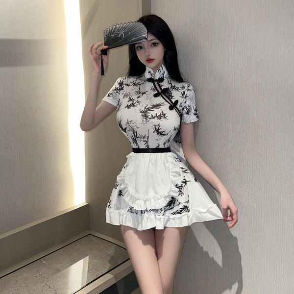 A stylish model showcases a black-and-white chinese new year-themed dress inspired by red silk, featuring lace detailing and ...