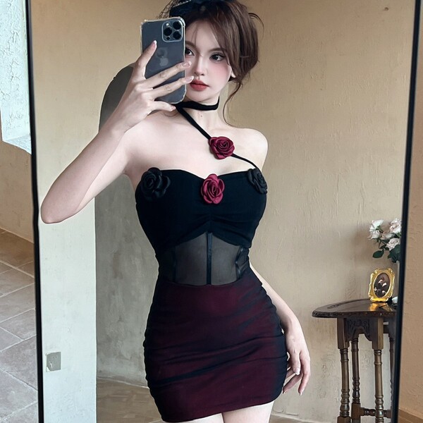 Woman in dark glam mesh lace floral halter bodysuit, sexy backless bodycon dress with red roses, posing in mirror selfie.