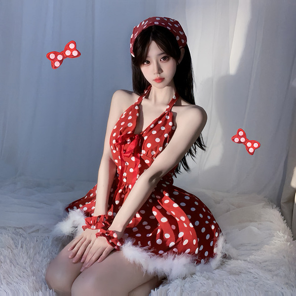 A woman wears a red polka dot babydoll nightgown with scalloped trim and halter neck, paired with a matching headband and bow...
