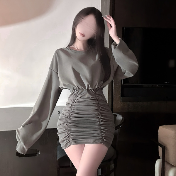 Woman wearing a gray pleated mini skirt with a corset waistline, showcasing the hong kong style flirty pleated mini skirt.