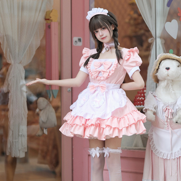 A cute girl wearing a japanese-style cosplay maid dress, featuring a pink uniform with ruffles and bows, perfect for role pla...