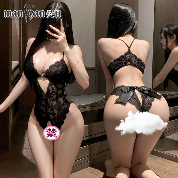 Woman modeling black lace temptation open-crotch bodysuit, sheer lingerie set with floral lace and bow back detail.