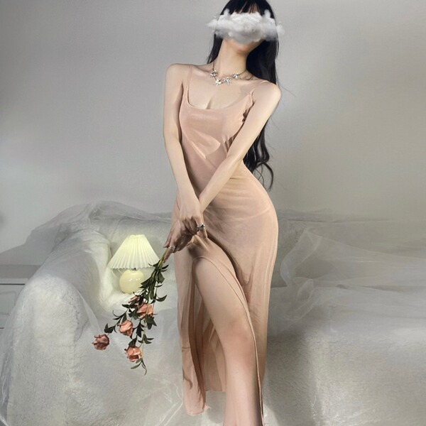 A woman poses elegantly in a sheer, nude-colored nightgown with lace detailing, holding roses. the dress features a flowing d...