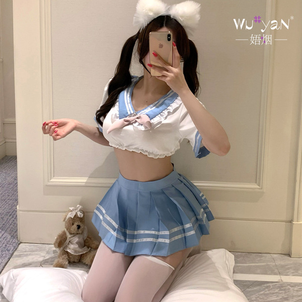 A person wearing a playful schoolgirl outfit, featuring a blue pleated skirt and sailor-style top with white accents. the ens...