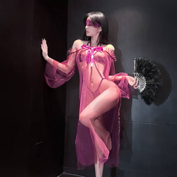 Woman in sensual lace lingerie set with sheer mesh and high-end stockings, holding a feather fan.