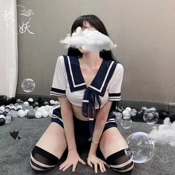 Woman in a sexy maid costume with sheer stockings, kneeling on the floor surrounded by bubbles and decorative elements.