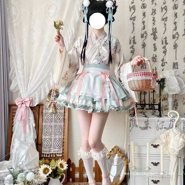 A woman models a sweet lolita maid dress set featuring a floral kimono, ruffled skirt, and lace stockings, perfect for cospla...