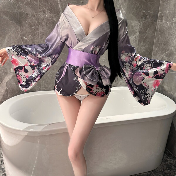 A woman poses in a luxurious yasise night fantasy lingerie set, featuring a deep v neckline and elegant kimono-style design w...