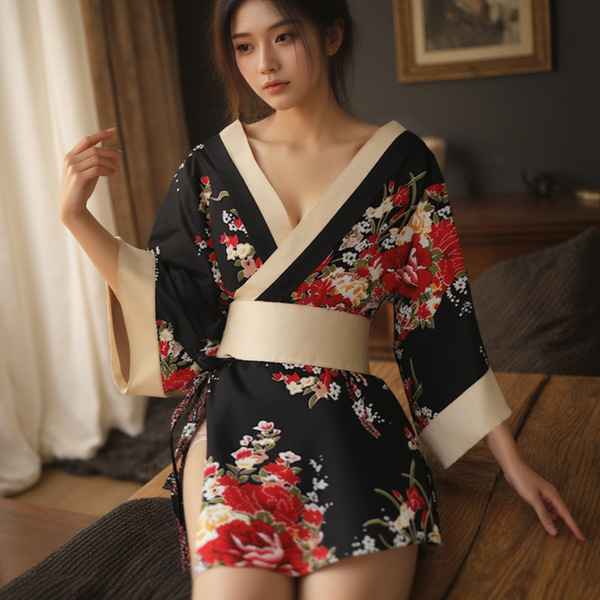 A woman wears a black floral japanese-style robe with red flowers, beige accents, and a tie belt, ideal for couples sleepwear...