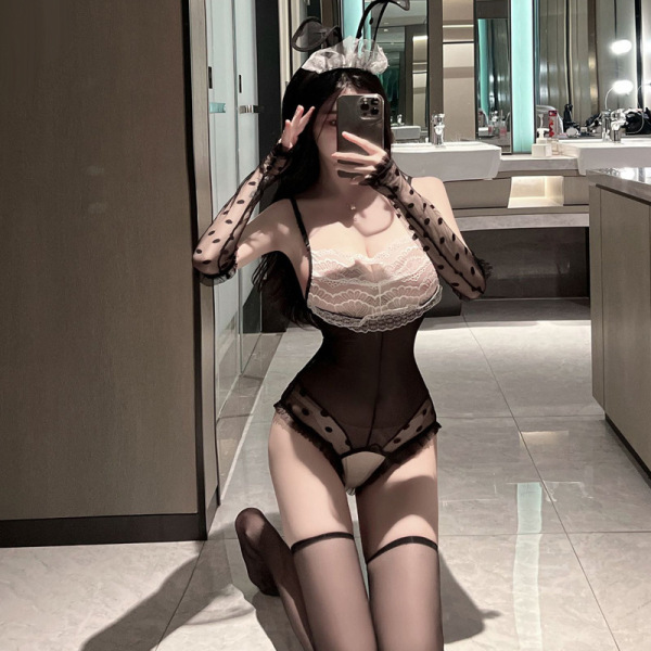Woman in suoqing sexy bunny lingerie set - sheer lace open-crotch bodysuit with polka-dot gloves and bunny ears, posing in ba...