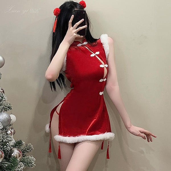A woman poses in a festive red cheongsam outfit, featuring sheer bust design and white fur trim. the dress includes playful p...