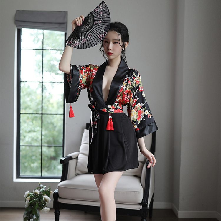 A woman poses elegantly in a black japanese anime-themed sleepwear set, featuring sheer kimono-inspired design with floral pa...