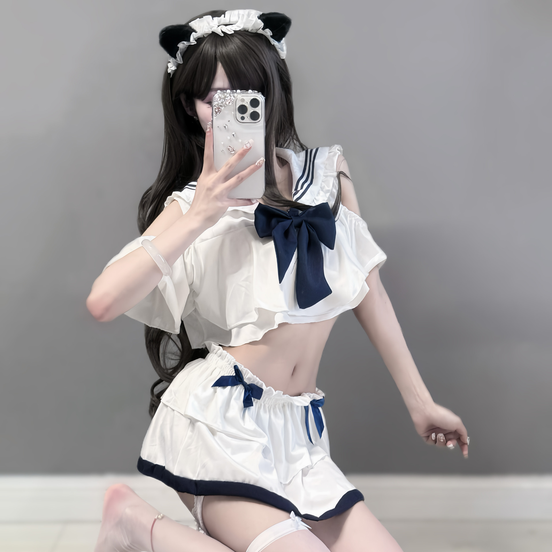 Seductive schoolgirl lingerie set featuring a sailor-style top with ruffles and a bow, paired with matching shorts, perfect f...