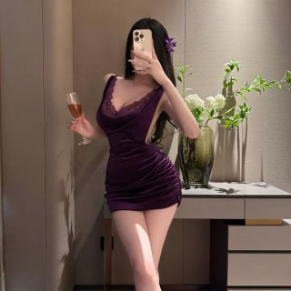 Woman in purple lace bodycon dress holding wine glass, elegant bedroom setting with floral decor.