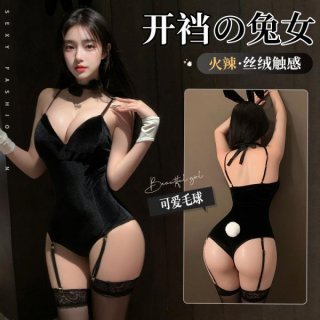 Woman modeling black velvet bunny costume with open-crotch design, lace garters, and fluffy tail. includes gloves and choker ...
