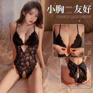 Woman modeling a black lace open-crotch bodysuit with sheer detailing, bow accents, and adjustable straps—ideal for seductive...