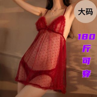 Woman wearing red plus size lingerie sleep set with sheer polka dot fabric and feather trim, perfect for date nights.