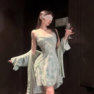 Woman wearing chaomu lace print lingerie set with sheer cami, matching briefs, and robe, holding wine glass.