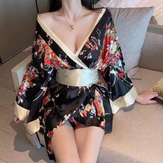 A woman wears a black floral japanese kimono-style lingerie with butterfly print, featuring a deep v-neck and flowing sleeves...