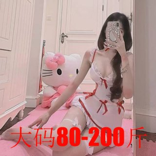 Woman in plus size white maid costume with red bows, posing beside hello kitty plush.
