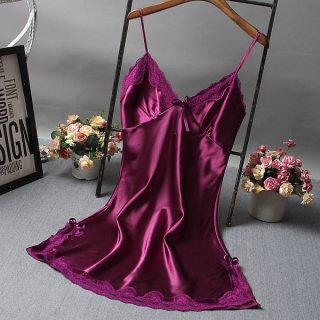Elegant purple lace-trimmed satin sleep dress on hanger, styled with floral decor for a luxurious bedroom look.