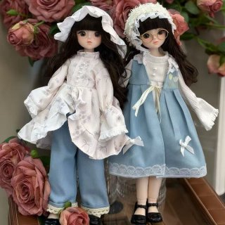 Two adorable 30cm bjd dolls dressed in charming outfits, featuring delicate lace and bows, perfect for collectors or gifts.