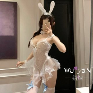 Woman in white lace bunny lingerie set with ears, garters, and playful jk-style details for seductive sleepwear or roleplay.
