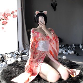 A woman poses with cat ears, wearing a pink floral japanese kimono-style lingerie set. the elegant design features long sleev...