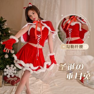 A woman models a festive red and white christmas-themed lingerie set, featuring a flirty bralette with lace-up details and a ...