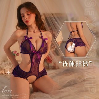 Woman wearing purple lace bodysuit with open-crotch design, featuring bust-friendly cut and sheer detailing for sensual sleep...