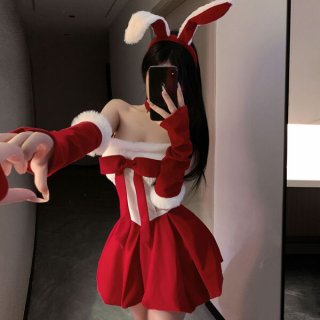 Woman in red and white christmas bunny costume with fluffy trim, bow, and ears, posing playfully for mirror selfie.