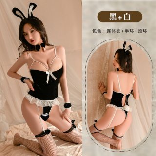 Woman modeling black and white bunny girl costume with lace bodysuit, bow, garter stockings, and ears.