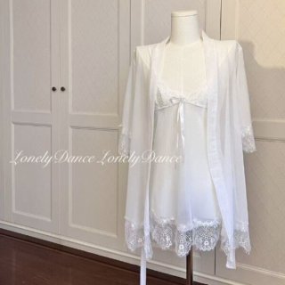 White lace sleepwear set with sheer mesh cami, shorts, and matching robe on mannequin.